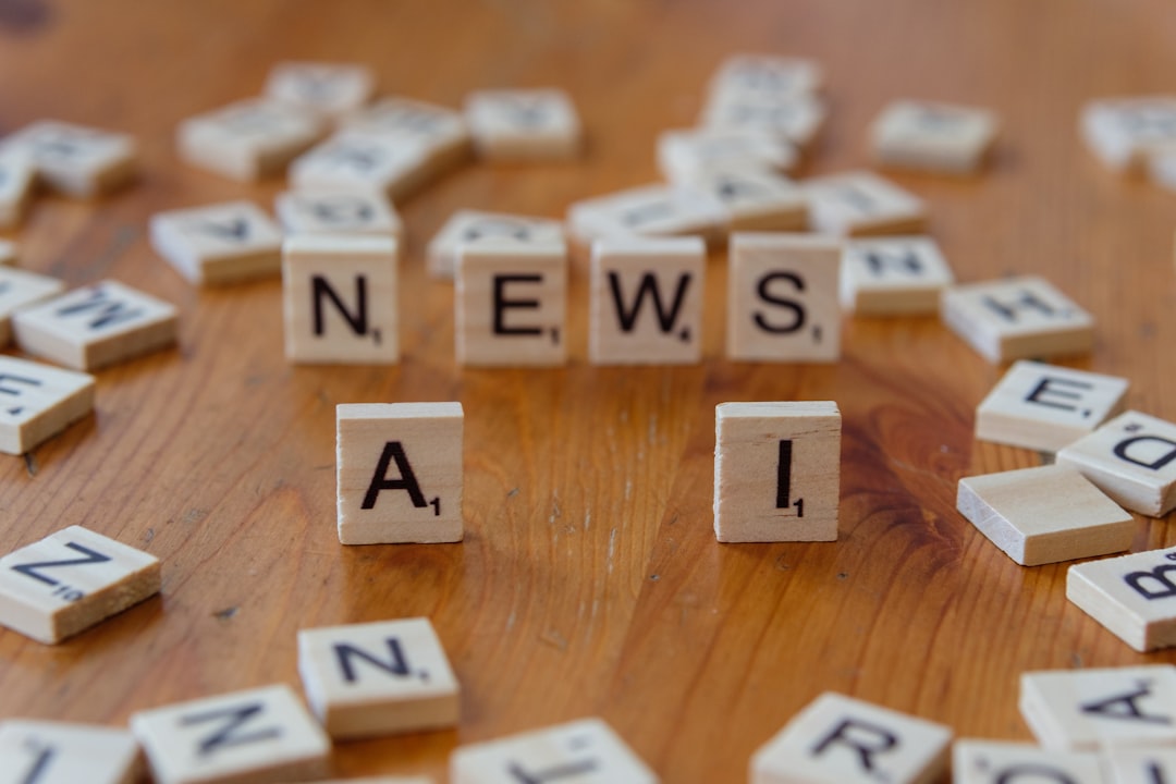 A wooden table topped with scrabble tiles spelling news and mail