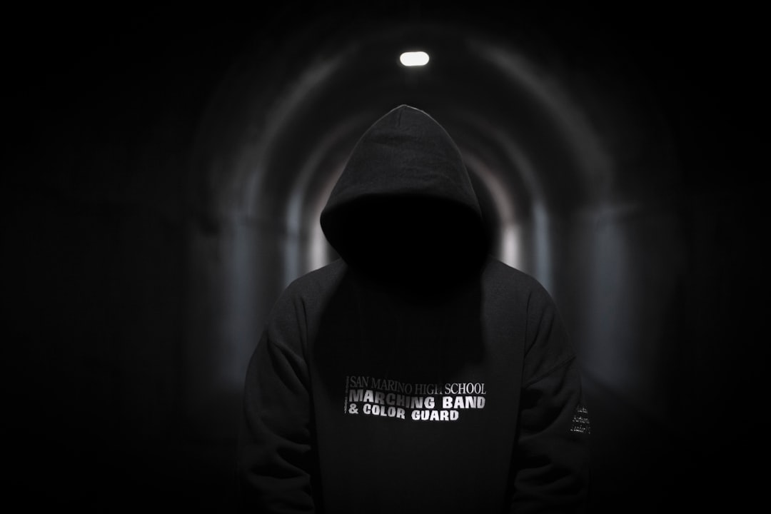 a person in a dark tunnel with a hoodie on