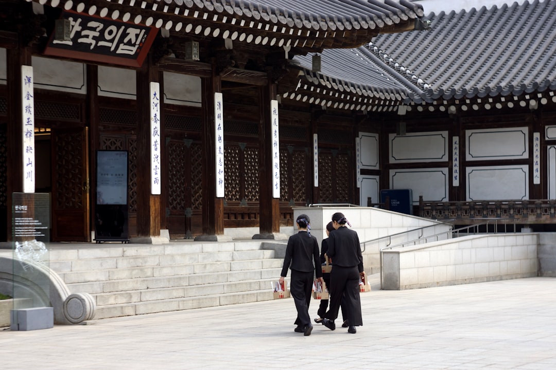 A couple of people that are standing in front of a building