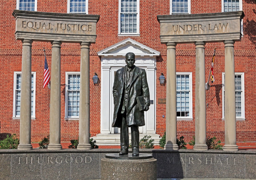 A statue of a man standing in front of a building