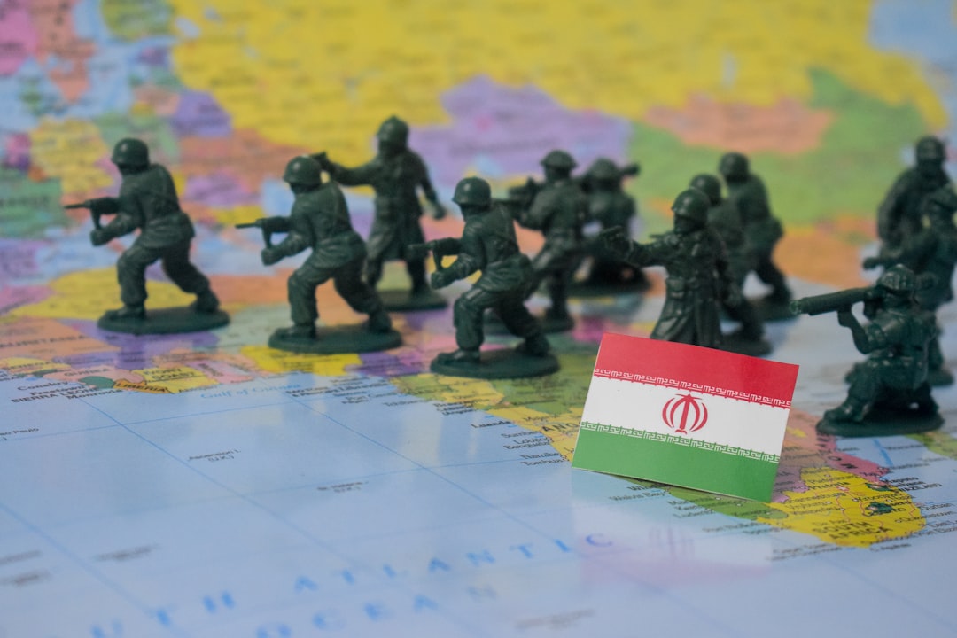 Toy soldiers on a map with iran flag.