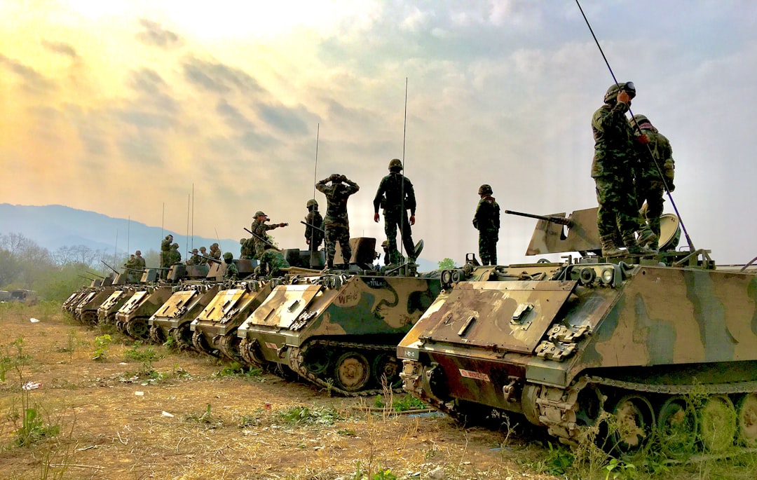 soldiers on top of battle tanks